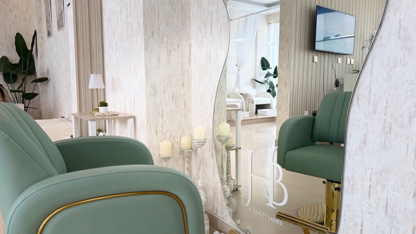 H Beauty salon mirror and green styling chairs